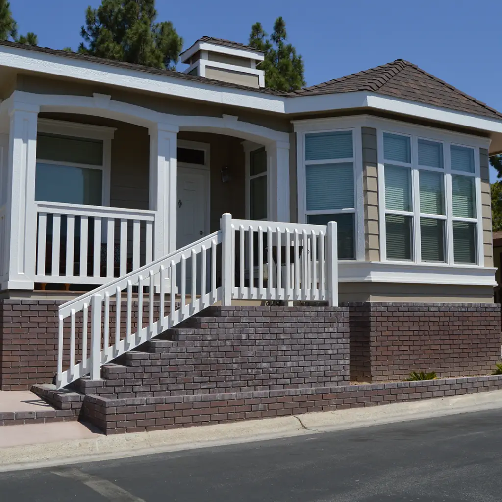 New Manufactured Home with stone skirting and large porched with loans by Compadre Mortgage.